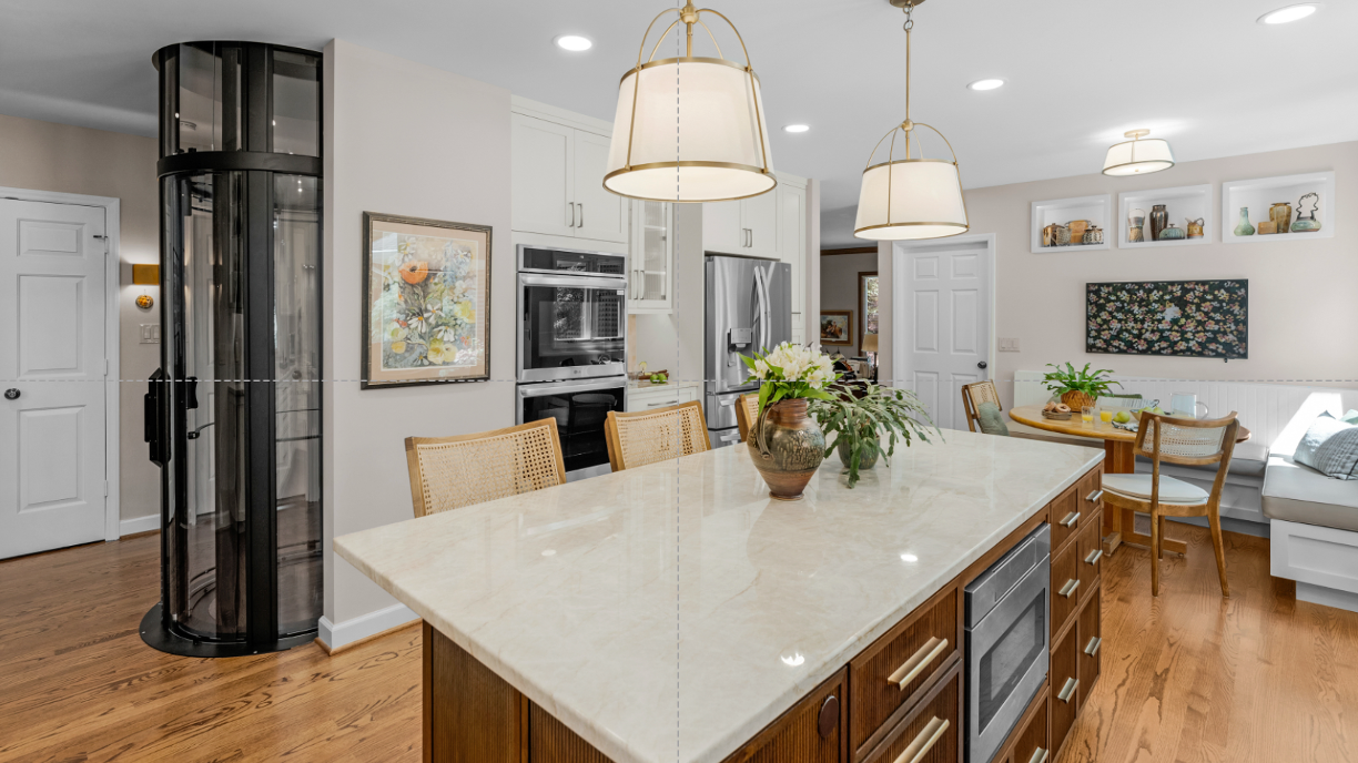 Open kitchen and adjoining outdoor patio living area filled with natural light