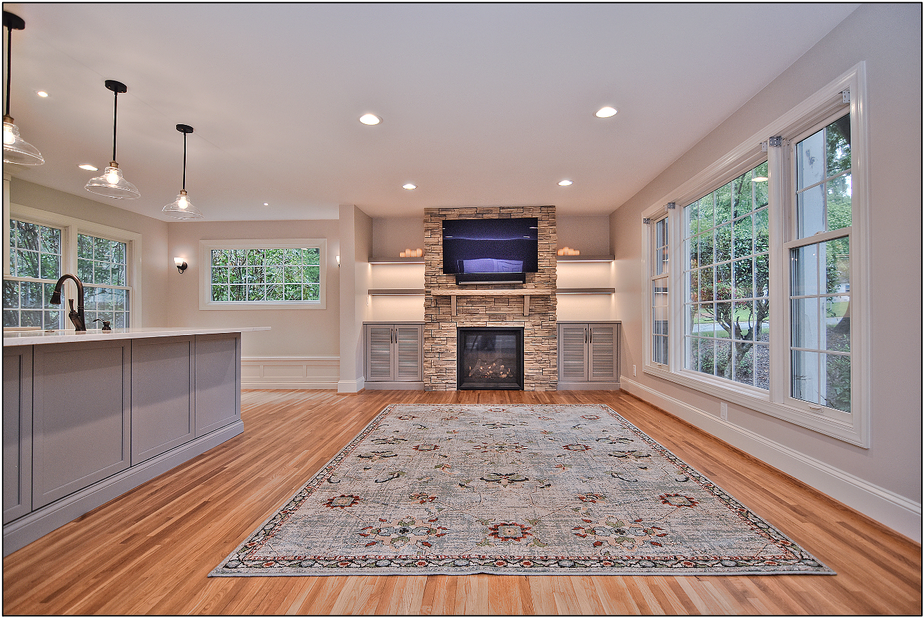Remodeled tri-level kitchen and living space sharing a central upgraded fireplace